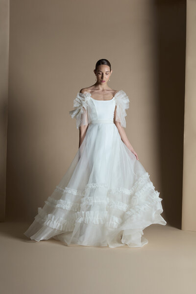 black and white image bride wearing strapless satin wedding dress with long train