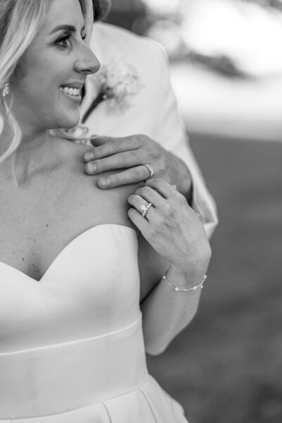 Close-up of bride and groom’s hands showcasing their wedding rings, capturing a timeless and intimate moment.