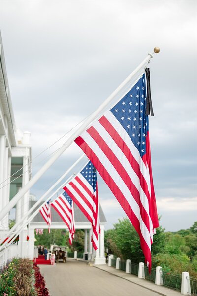 American flags hanging from the porch at the Grand Hotel
