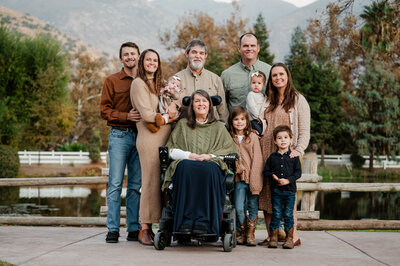 Extended family posing together in front of the pond at Springville Ranch