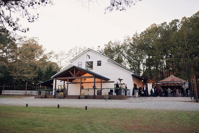 Exterior view of Southern Grace Farms, showcasing the modern farmhouse-style venue surrounded by rolling pastures and scenic landscapes near Raleigh, NC.