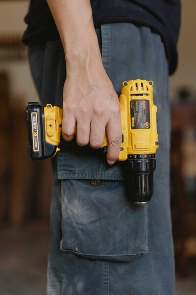 Full-service general contractors in Dallas, TX, using a drill for a home renovation project. This image highlights the professional tools and expertise employed by Dallas contractors to deliver high-quality renovation and construction services.