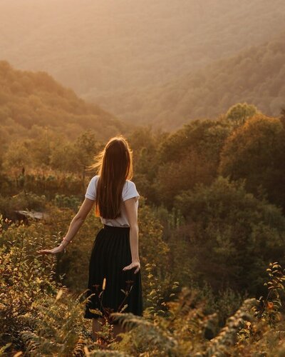 woman in field with soft sunlight