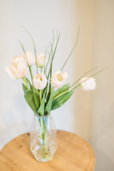 Close up of white roses and green leaves in a vase