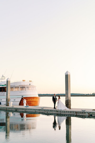 Bride and groom at Savannah Yacht Club posing on the dock
