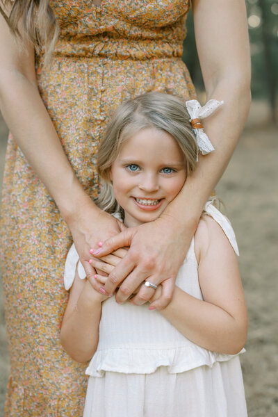 mom holding daughter at a sacramento family session