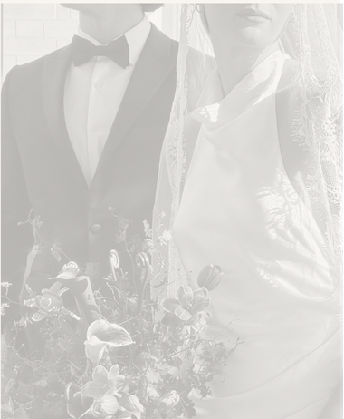 Bride holding a bouquet next to groom 