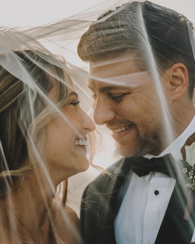 couple hiding under veil at rumbling bald lake lure