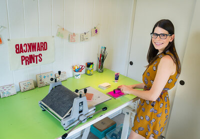 Storytelling branding photography of woman owned design business creating homemade stamped greeting cards.