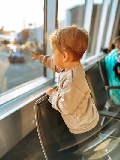 baby eating food in high chair 