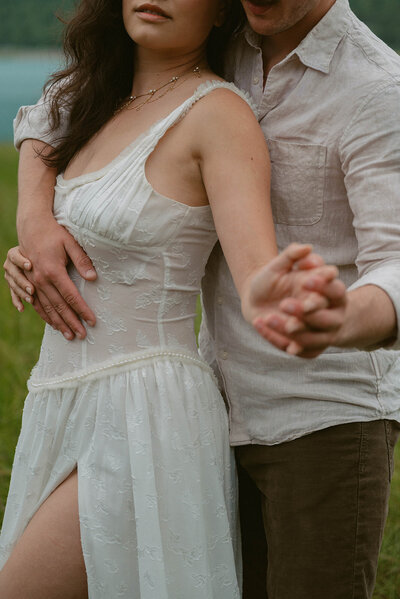 Couple kissing with the mountains in the background