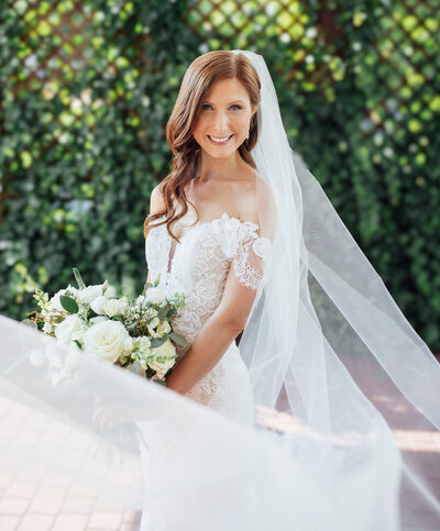 Bride posing with flowing veil against ivy-covered wall | Summer Wedding at The Hamilton Manor | Hamilton Township, New Jersey