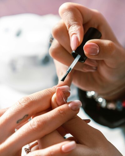 A nail tech sculpts a nail in a private nail salon