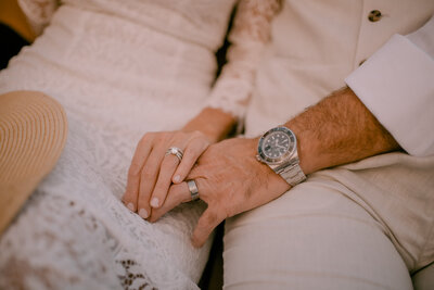 Bride and groom show off their silver wedding rings.