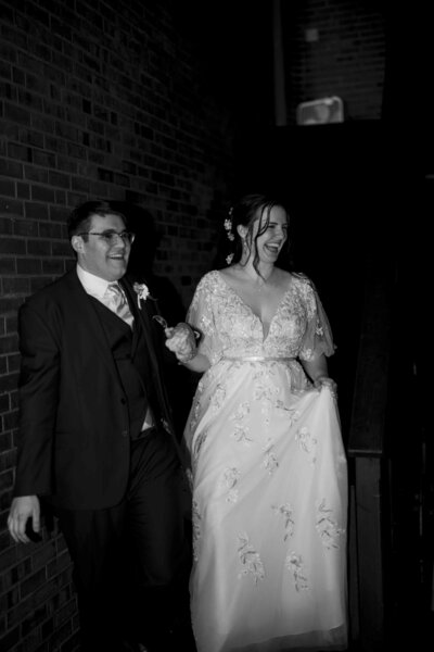 Bride and groom making grand entrance into the ballroom . Black and white photo