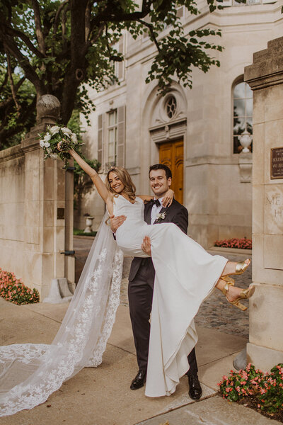 Groom Carries Bride in front of Meridian Place in Washington DC