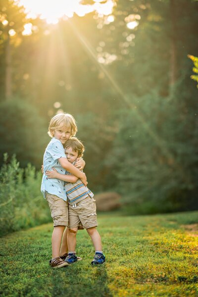 Two brothers are embracing each other at their family photoshoot in Senoia, GA.