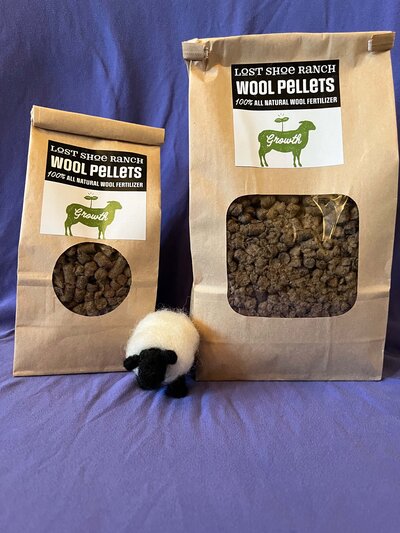 Bags of Lost Shoe Ranch 100% natural wool pellets fertilizer for sustainable lawn and garden irrigation.