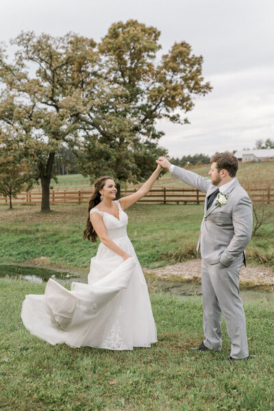 Bride and groom dance in a field