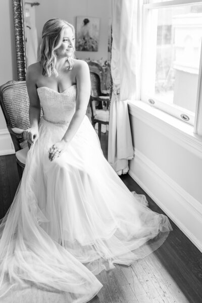 Bride looks out the window in her bridal suite before her Tampa wedding