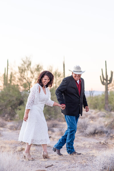 man and woman in desert holding hands