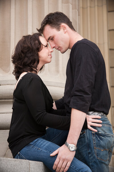 Engagement couple leaning in  forehead  to forehead at Alberta Legislative Building