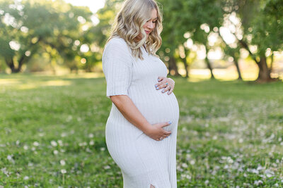 mom holding baby bump for maternity photos