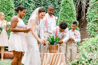 bride and groom with children during wedding ceremony in the Old Market Omaha