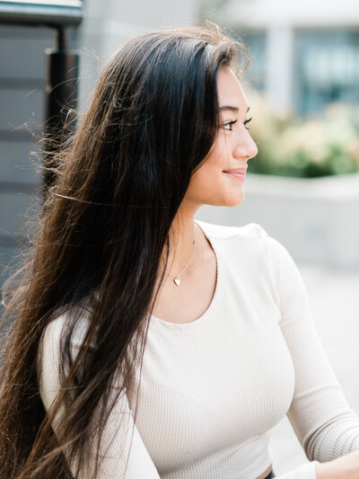 senior girl in white shirt posing for portraits in cleveland