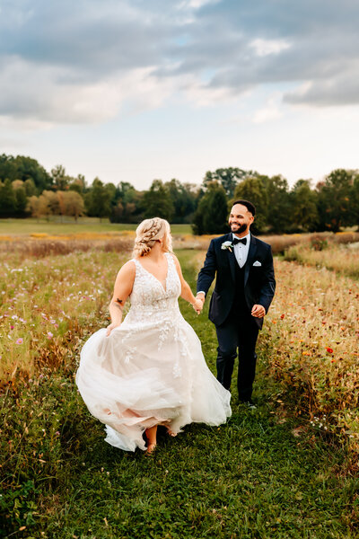 Bride and Groom walk out of wedding ceremony holding hands celebrating in hilliard ohio