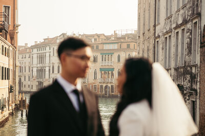 A captivating scene as the couple gazes into each other's eyes, embracing the enchanting charm of Venice's iconic square amid the winter serenity