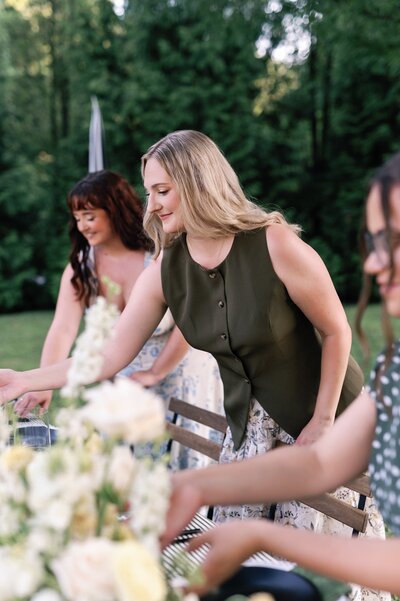 three woman fixing a pretty table