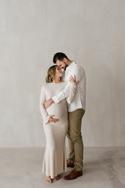 photo of pregnant woman being embraced by her husband taken by Lifestyle photographer Madison WI