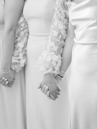 Fine art detail shot of bridal fashion featuring elegant textured sleeve in soft light