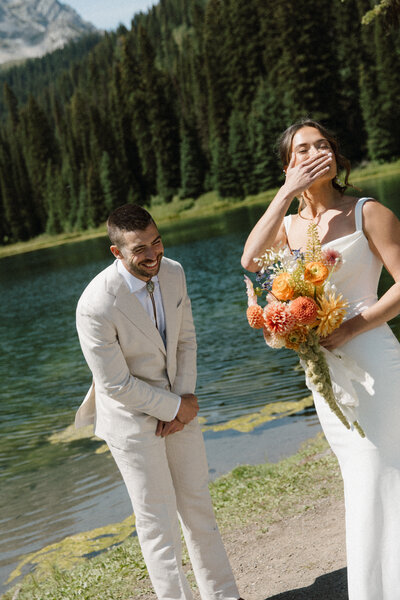 bride and groom react during their first look at their fernie wedding.