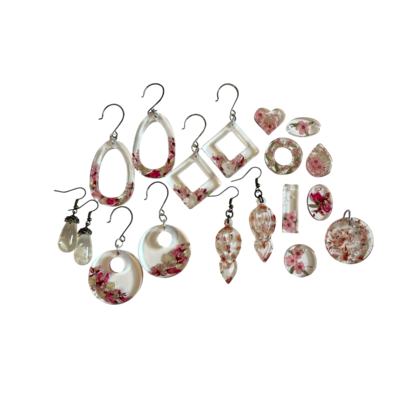 different earrings made from resin  in a variety sizes next to each other 
