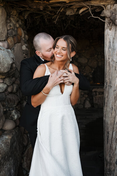 Bride and groom embracing during a golden hour photoshoot