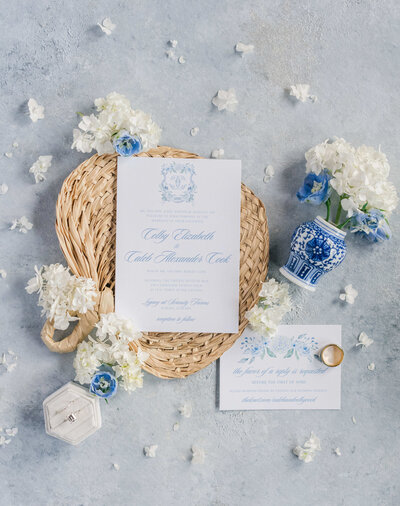 Bridal details stationary and florals ona. blue background with gold accent