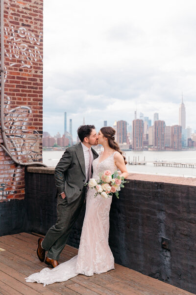 a bride and groom walk down a path in prospect park