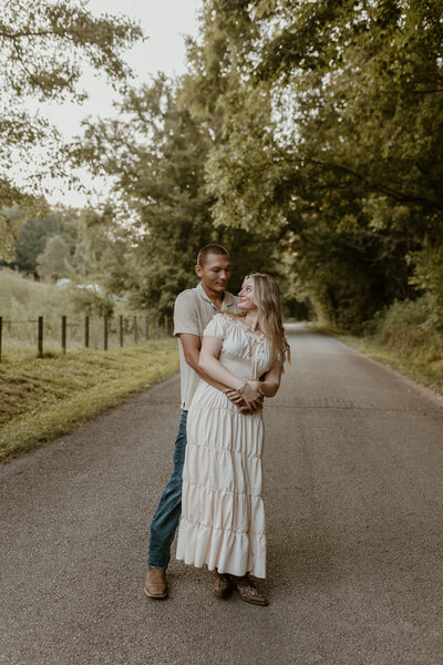 engagement session located in columbia Tennessee where the couple is hugging each other.