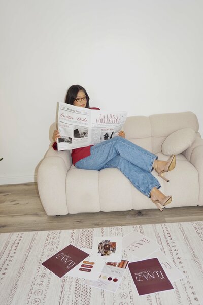 red business cards on a table next to roses 