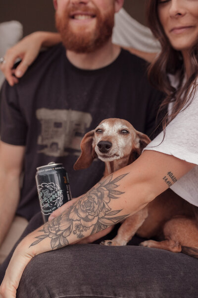 couple posing with dog