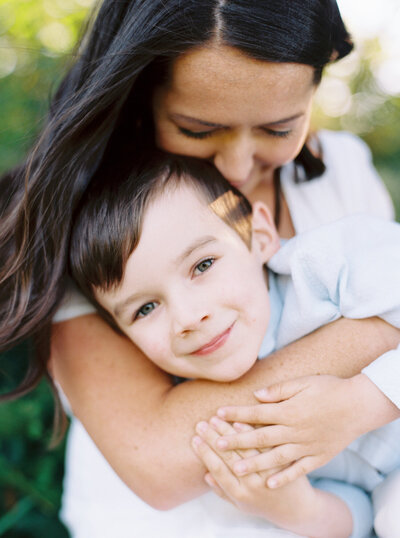 Brittany Carvalho - Seattle family photographer posing for a photo with her son. 