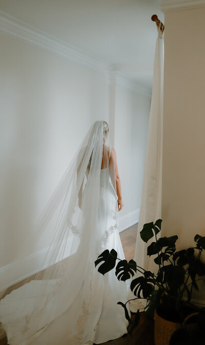 Bride leaving her getting ready room to walk down the aisle.