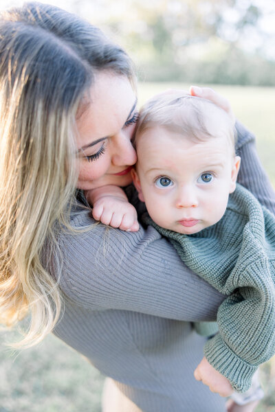 Mom kissing baby boy for Tampa photographer