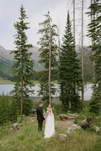 Elegant bridal portrait with wind-blown veil and soft mountain light | Colorado fine art photographer