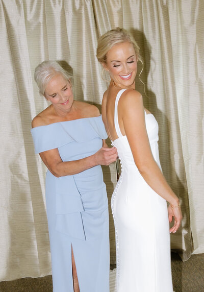mom of bride helping bride get ready