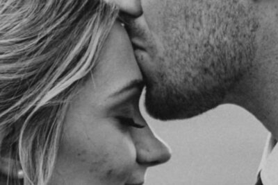 Close-up image of a boy kissing a girl on the forehead