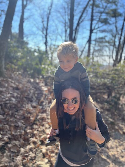 photo of kelly francis with child while hiking in north carolina woods