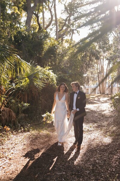 indie west portfolio image of bride and groom walking away from venue on wedding day